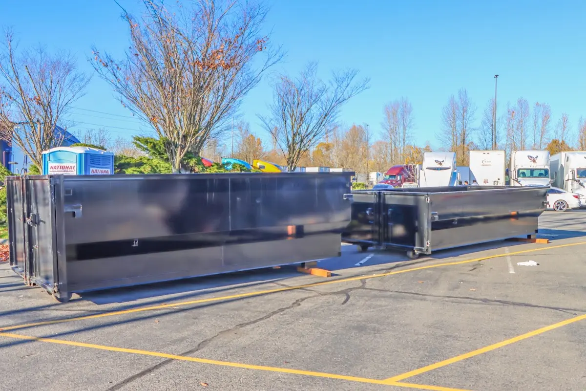 Professional dumpster rental service with roll-off container on residential driveway in Leeds